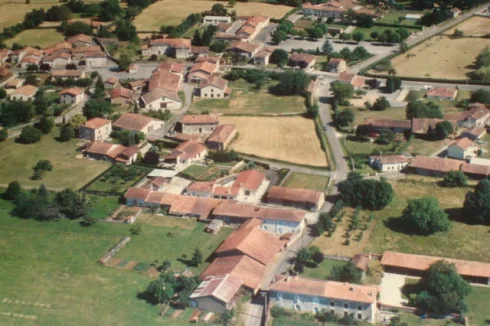 The land is on the near corner of the straw coloured field in the centre of the picture