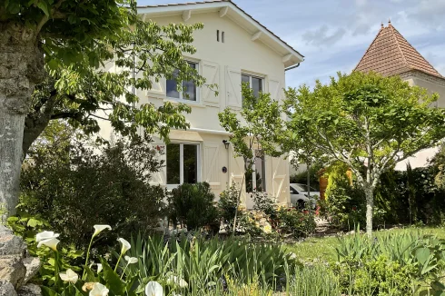 Rear of house and a terrace with awning