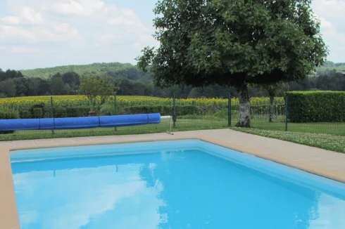 Pool overlooking fields of sunflowers.