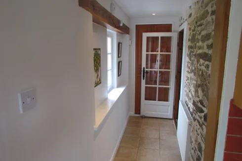 Cottage.  Corridor between main living room and kitchen.