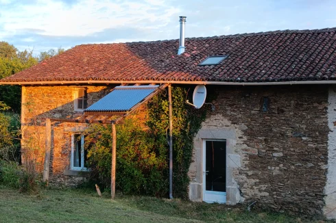 South view of habitable house with solar hot water panel