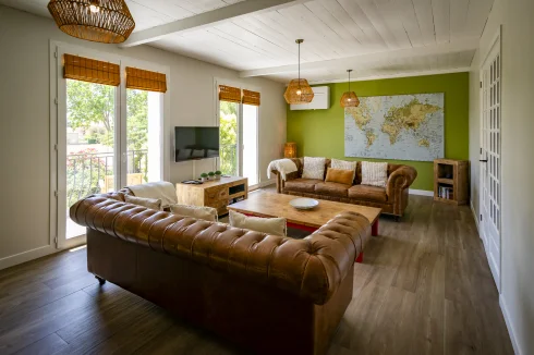 Gîte living room leading to balcony with warm/cool AC