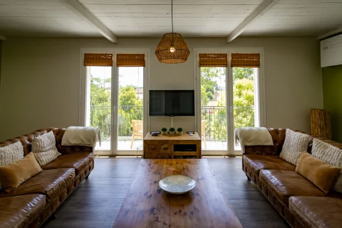 Gîte living room leading to balcony with warm/cool AC