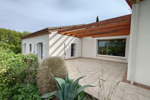 Left side facade (patio and large bay window)