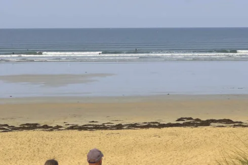 The famous Sainte-Barbe surf spot, with a supervised swimming area in the center, surf zone to the left, and kite surfing to the right