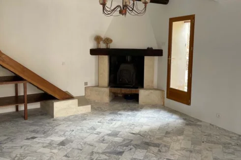 Living room with fireplace and cast iron stove