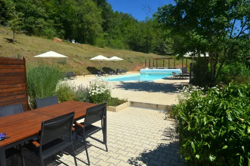 the terrace of a gîte overlooking the swimming pool