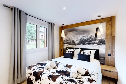Wooden bedroom with mountain poster